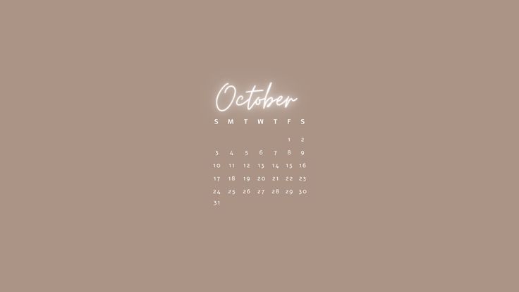 a desktop calendar with the word october written in cursive writing on it's side