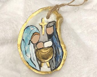 a ceramic ornament with a painting of jesus and mary on it's face