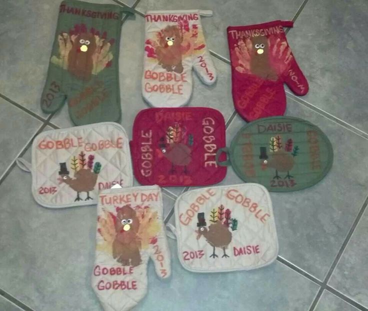 five oven mitts with turkey sayings on them sitting on the floor next to each other