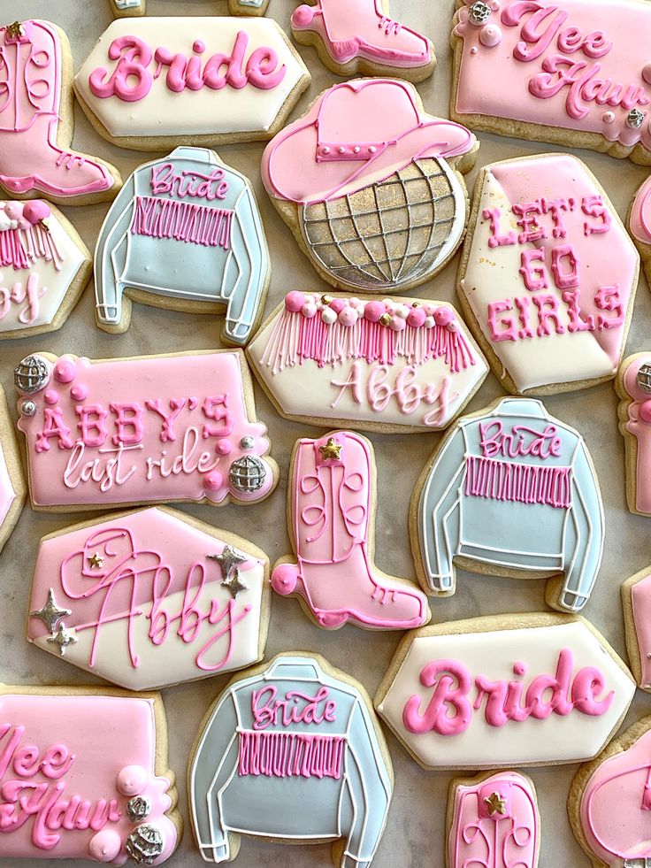 pink and blue decorated cookies with the word bride on them