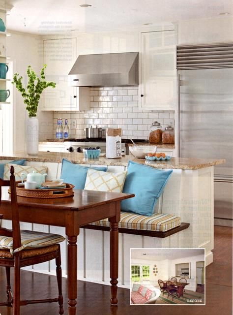 a kitchen with a table and chairs next to a couch in the middle of it