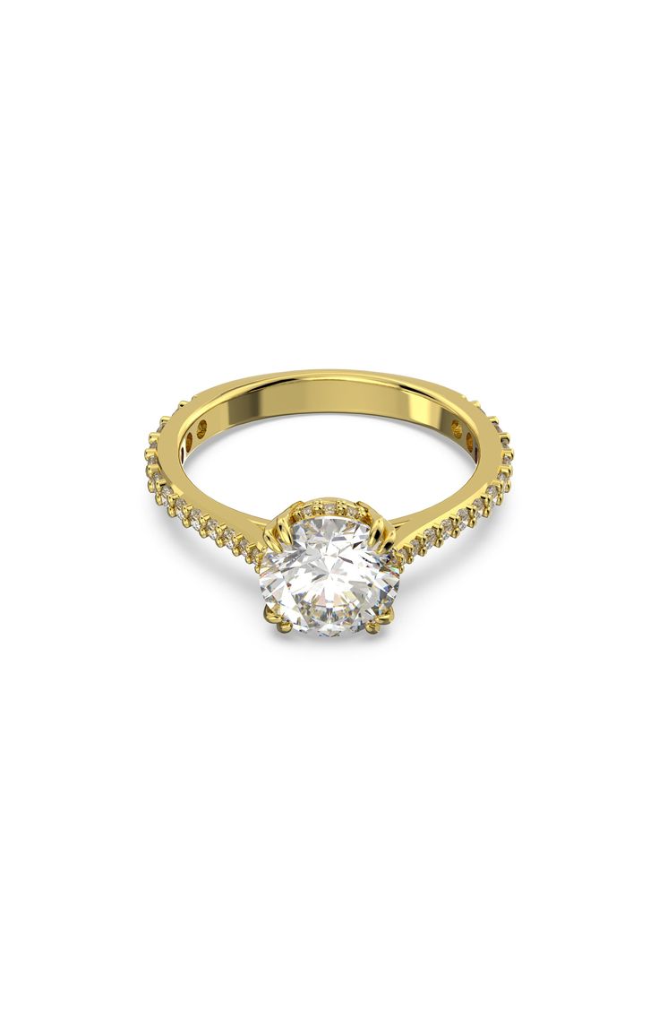 a yellow gold ring with an oval cut diamond in the center and pave set shoulders