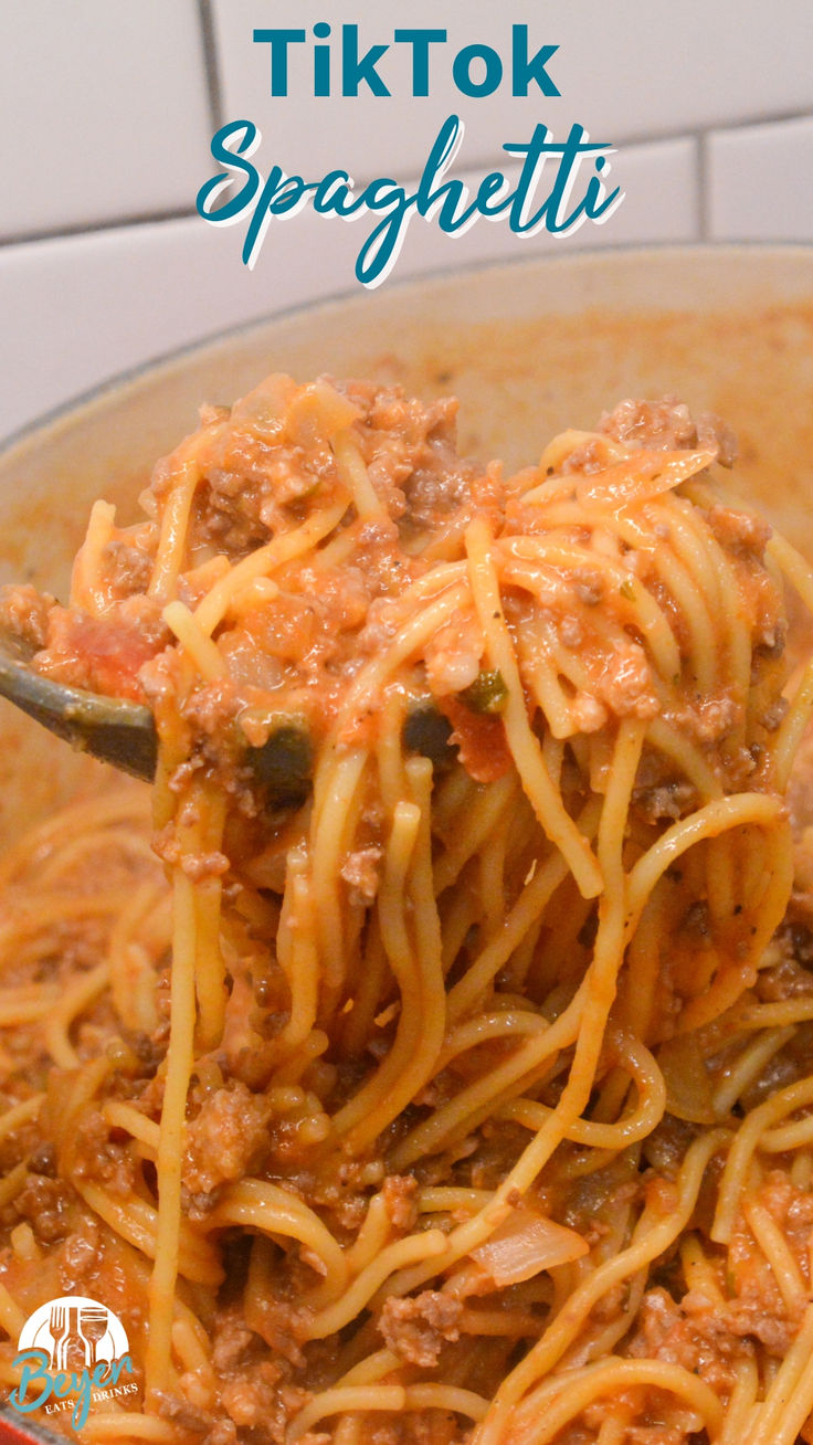 a spoon full of spaghetti with meat and sauce