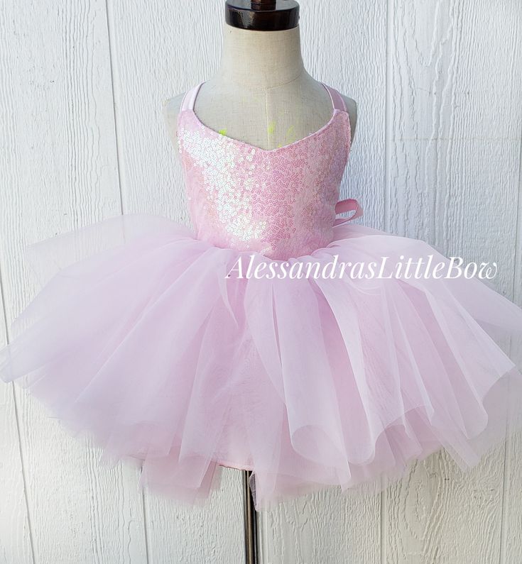 Our Ballerina Couture dress features a super voluminous skirt, sparkly sequin bodice with a beautiful criss cross back that makes it perfect and adjustable giving it room for growth. Our dresses usually tend to fit a size up and a size down, perfect for photographers client closets. Handmade to order in the USA. Customs welcomed Select the color you would like from the drop down. Menu, We also have Black, Red, Royal Blue, Yellow, mostly any color, send us a message if you need further help. Sleeveless Sequin Dress With Glitter Tulle, Summer Pageant Dress With Sequins, Sleeveless Embellished Dress With Glitter Tulle, Sleeveless Sequin Dress For Dress-up, Pageant Ball Gown Dress With Corset Back, Sleeveless Sequined Princess Wedding Dress, Pink Sequined Ball Gown For Parties, Summer Ball Gown For Dress-up, Fitted, Summer Ball Gown For Dress-up Events