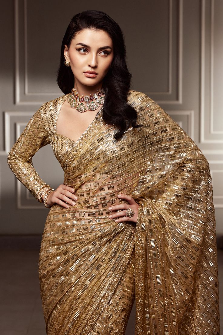 A divine metallic gold tulle #mymmsaree embellished with our signature sequins. Coupled with a metallic gold sweetheart neckline #mmblouse and juliet sleeves, weaving an artisanal couture for your ceremonial celebration Golden Saree For Reception Bride, Golden Sequin Saree, Golden Saree Look, Metallic Saree, Golden Lehenga, Gold Saree, My First Story, Golden Saree, Gold Tulle