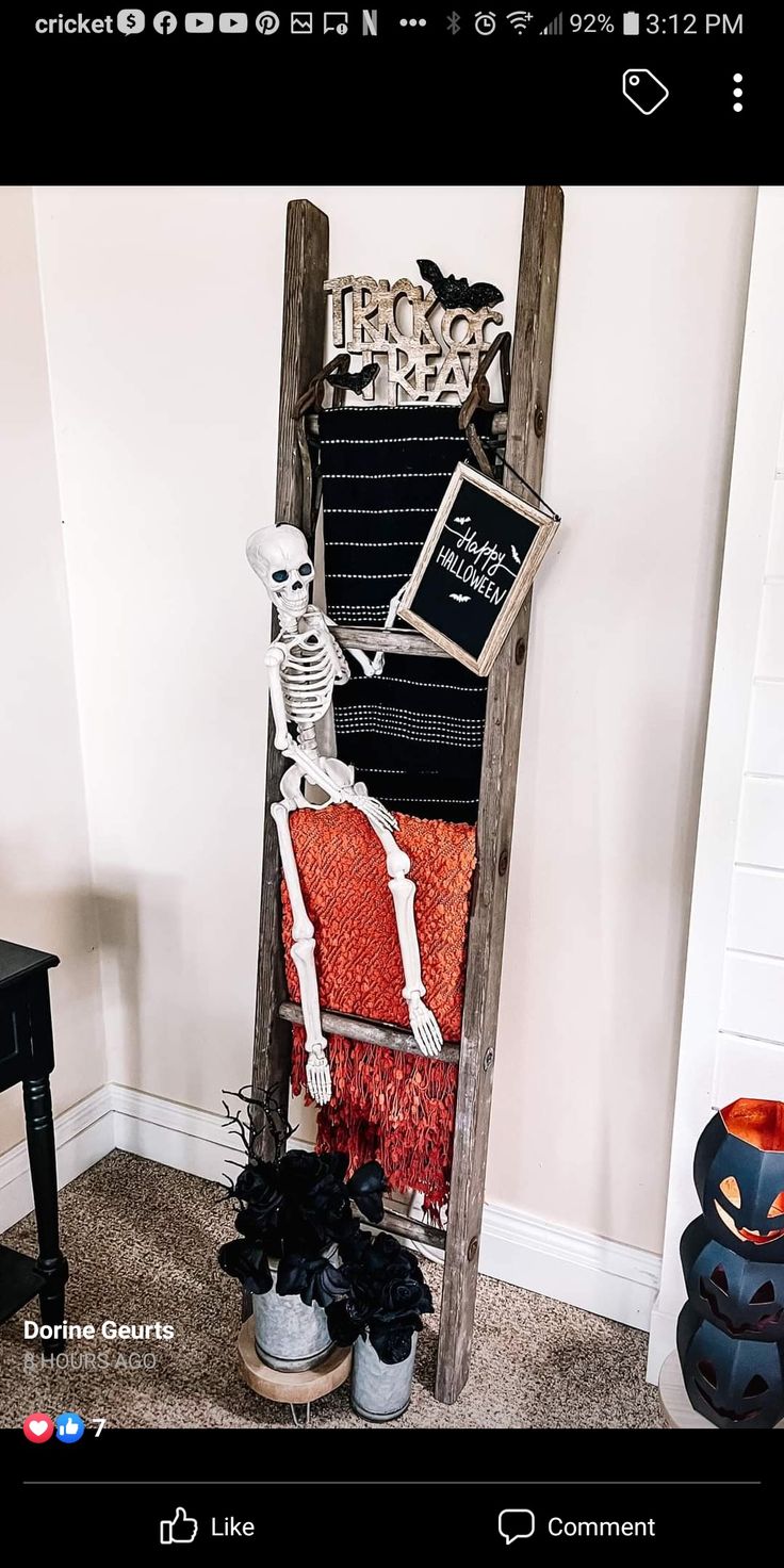 an old ladder decorated with halloween decorations