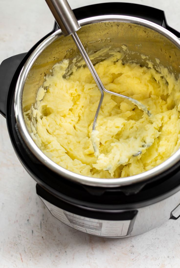 a large pot filled with mashed potatoes on top of a counter