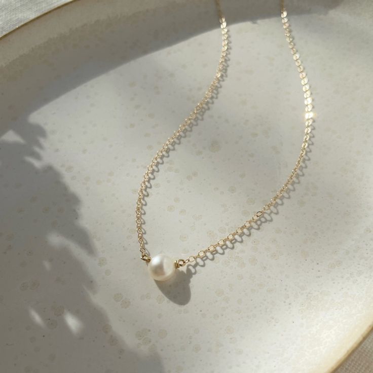 The epitome of classic, the Margot necklace (French for pearl) is a timeless piece to wear on special occasions or for an everyday polished look. Each purchase comes with an elegant, vegan leather box for storing + caring for your jewelry. DETAILS14k Solid Gold | Pearl measures 1/2 mmAvailable in 14", 16" or 18" Refined Pearl Chain Necklace As Gift, Refined Pearl Chain Necklace For Gift, Classic Single Strand Pearl Necklace In 14k Gold, Classic 14k Gold Pearl Necklace, Refined Pearl White Necklace For Gift, 14k Gold Clavicle Chain Pearl Necklace For Formal Occasions, Formal 14k Gold Pearl Necklace With Clavicle Chain, Elegant 14k Gold Pearl Necklace With Pearl Charm, Classic Akoya Pearl Clavicle Chain Necklace