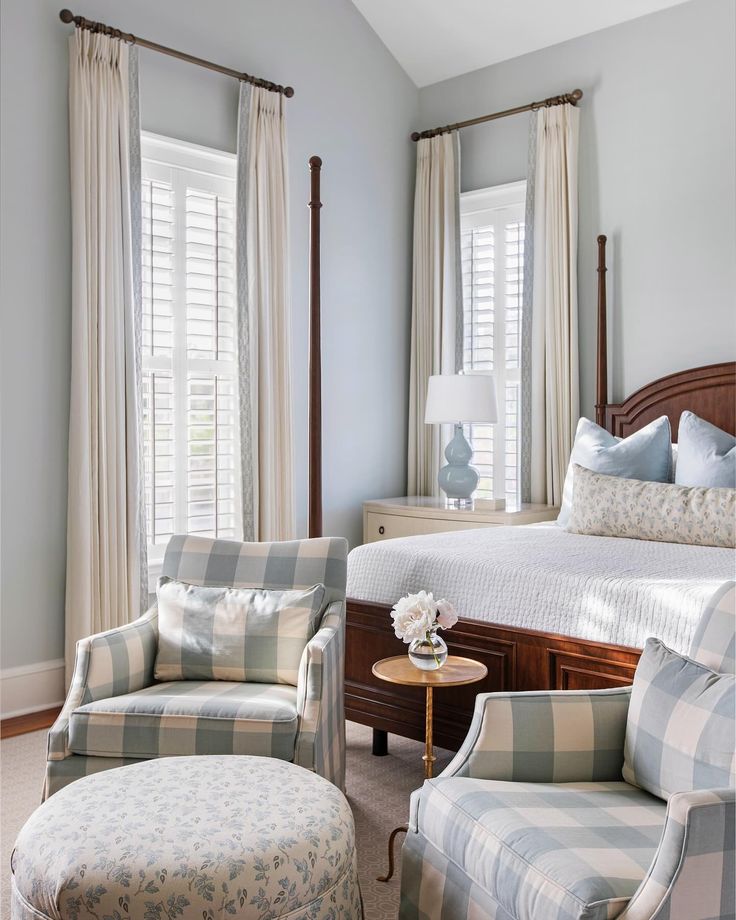 a bedroom with blue walls and plaid furniture