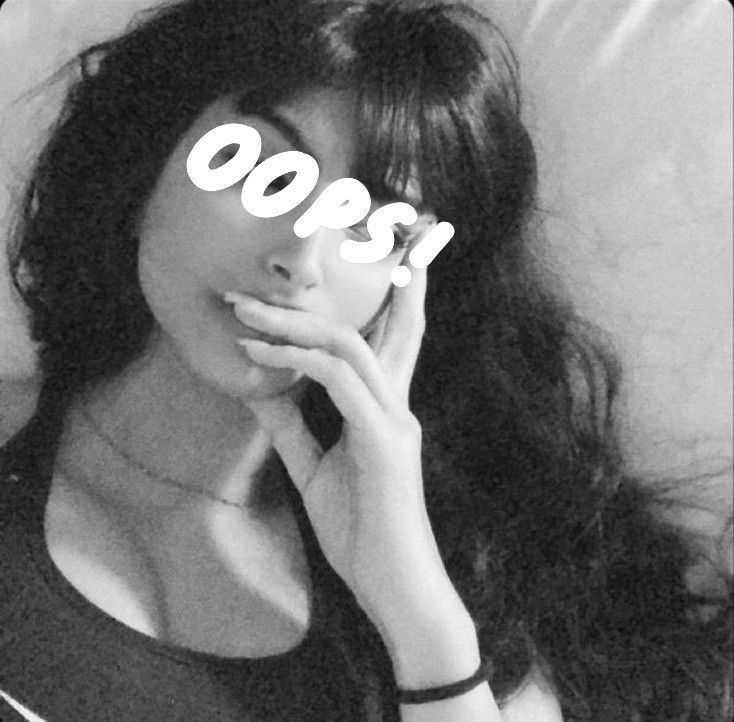 a woman laying in bed with the word boo spelled on her face and hands behind her head