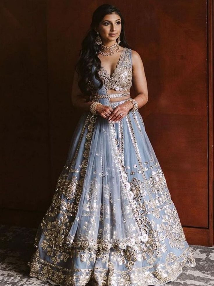 Introducing the Gorgeous Sky Blue Zari Work Net Wedding Wear Lehenga Choli - a stunning addition to your ethnic wear collection that is sure to make heads turn! Perfect for weddings, bridesmaids, receptions, and ceremonies.
Crafted in India from high-quality net fabric, this semi-stitched lehenga choli can be customized to fit up to 42 inches. The lehenga itself is designed with sky blue zari work and paper foil work, as well as a cancan attachment that adds volume to the skirt. The sky blue zar Bollywood Lengha, Orang India, Lehenga Choli Designs, Mirror Work Lehenga, Bridesmaid Lehenga, Choli For Women, Sabyasachi Lehenga, Indian Lehenga Choli, Reception Lehenga