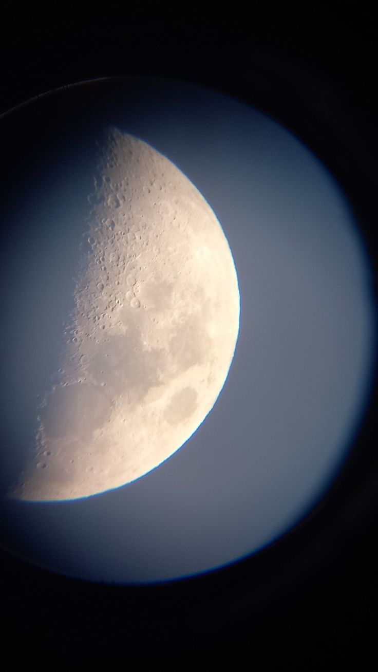 the moon is seen through an airplane window