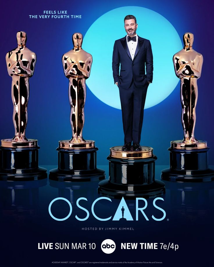 a man in a tuxedo standing next to three oscar statues on a blue background