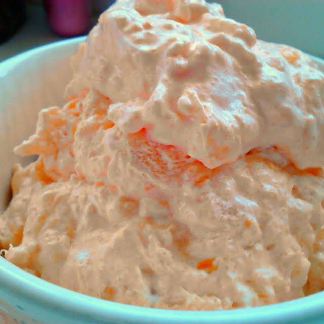 a bowl filled with whipped cream sitting on top of a table