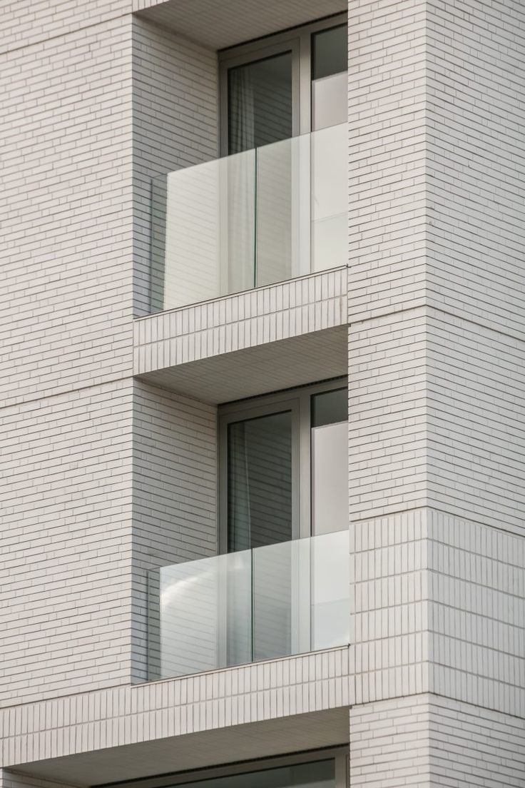 an apartment building with balconies and windows