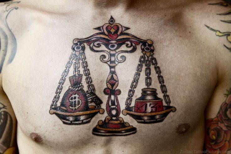 a man with tattoos on his chest has a scale and weight tattoo on his chest