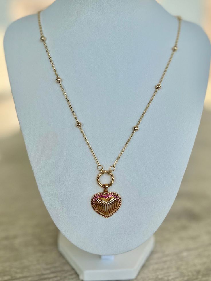 The Barbie Love Necklace is a stylish and endearing piece inspired by the necklace worn on Margot Robbie in the iconic Barbie Movie. Featuring a gold-filled heart shaped pendant surrounded by tiny pink gemstones on a dotted gold-filled chain, this necklace serves as a symbol of self love, positivity and the timeless appeal of Barbie. A perfect gift for anyone who adores Barbie or values the message of women empowerment. Available in multiple sizes Valentine's Day Rose Gold Heart Necklace, Pink Heart Charm Round Pendant Jewelry, Rose Gold Heart Charm Necklace For Valentine's Day, Rose Gold Adjustable Chain Necklace For Valentine's Day, Pink Round Pendant Jewelry With Heart Charm, Valentine's Day Rose Gold Adjustable Chain Necklace, Valentine's Day Rose Gold Chain Necklace With Heart Charm, Pink Round Pendant With Heart Charm, Rose Gold Plated Heart Shaped Necklace