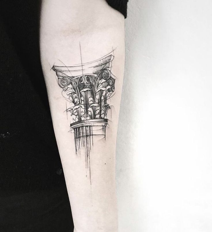 a black and white photo of a tattoo on the left arm with an artistic design