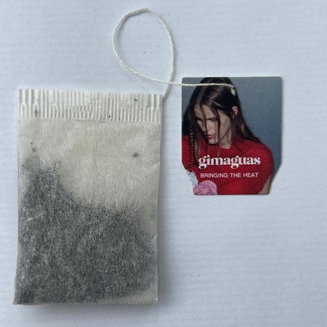 a piece of paper with a tag attached to it next to a package of hair dye