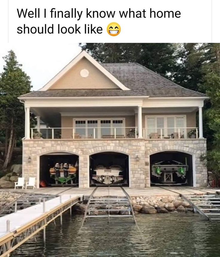 two garages are built into the side of a house on stilts over water