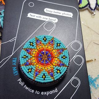 a cell phone case with beaded designs on it