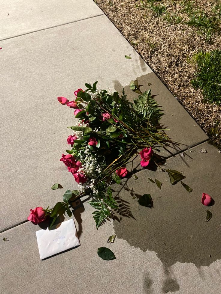 a bunch of flowers that are sitting on the sidewalk