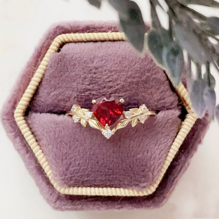 Cue the romance with our stunning Heart’s Desire Red Garnet Ring. This perfect expression of true love features a heart-shaped red garnet center stone along with a curved white topaz leafy band that adds a natural charm. A cherished keepsake that radiates love from every angle. ✦ Available in both 14K yellow gold vermeil (14K yellow gold plated over a sterling silver base) and 10K solid yellow gold. Red Heart-shaped Promise Jewelry, Red Heart Ring With Center Stone, Red Heart Ring With Center Stone For Wedding, Red Heart-shaped Rings With Center Stone, Red Heart Ring With Accent Stones For Valentine's Day, Red Heart Shaped Wedding Rings, Red Heart Ring For Valentine's Day Promise, Heart Shaped Red Ruby Ring For Wedding, Fine Jewelry Red Heart Ring As Gift