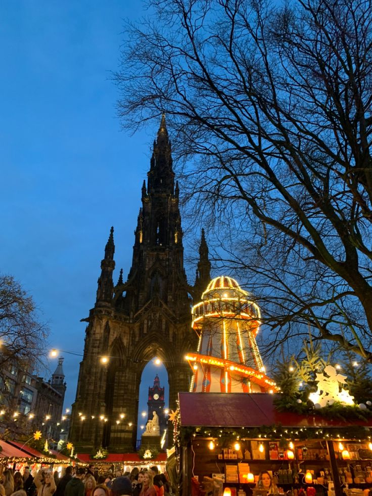 people are walking around an outdoor christmas market