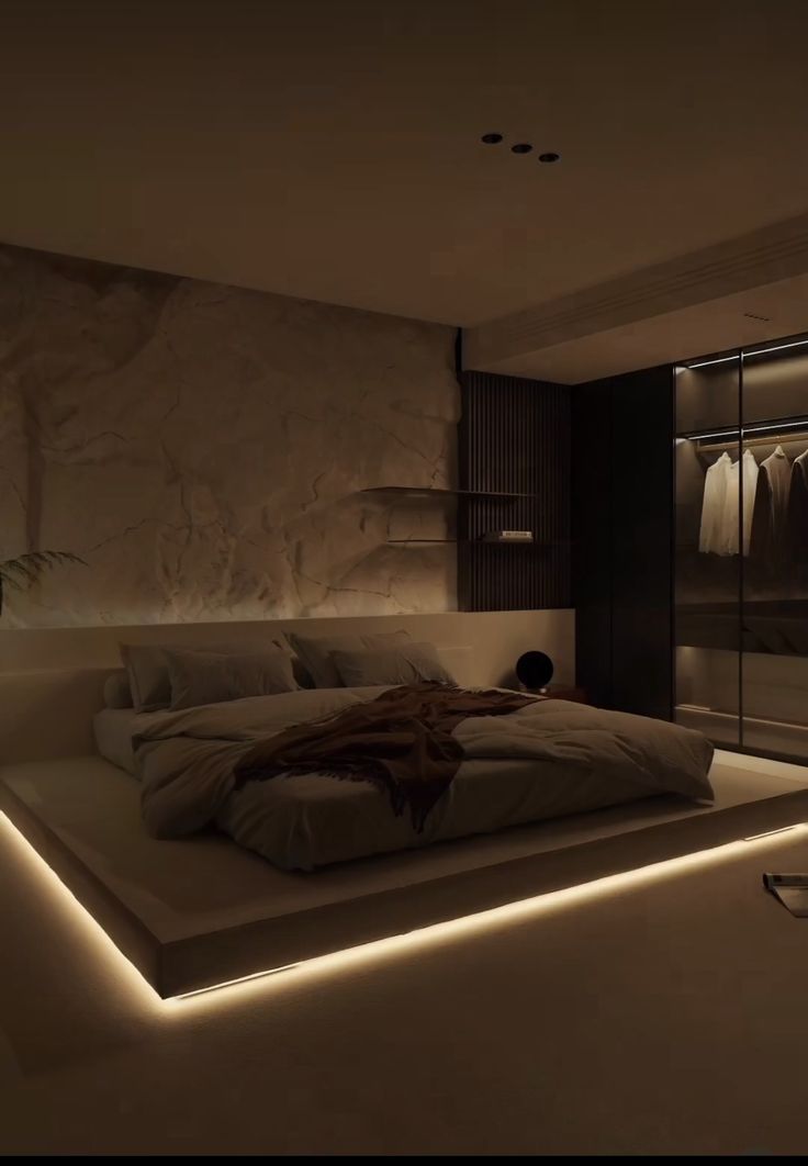 a large bed sitting in the middle of a bedroom next to a wall mounted closet