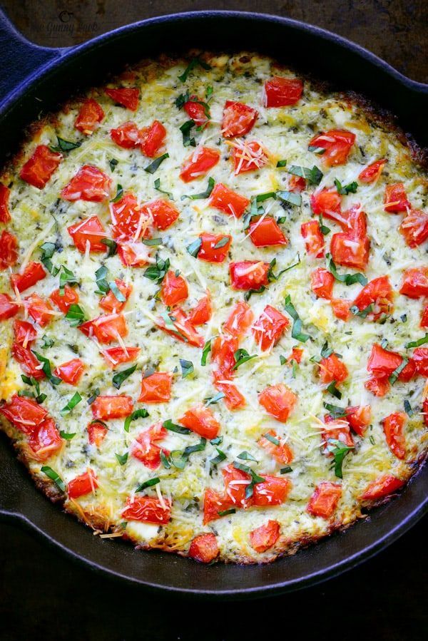 a pizza with tomatoes and cheese in a pan