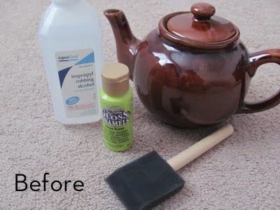 a brown teapot sitting on top of a carpet next to a bottle of cleaner