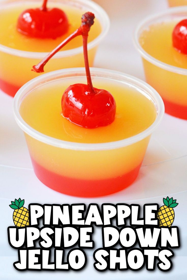 pineapple upside down jello shots in plastic cups with a cherry on the top