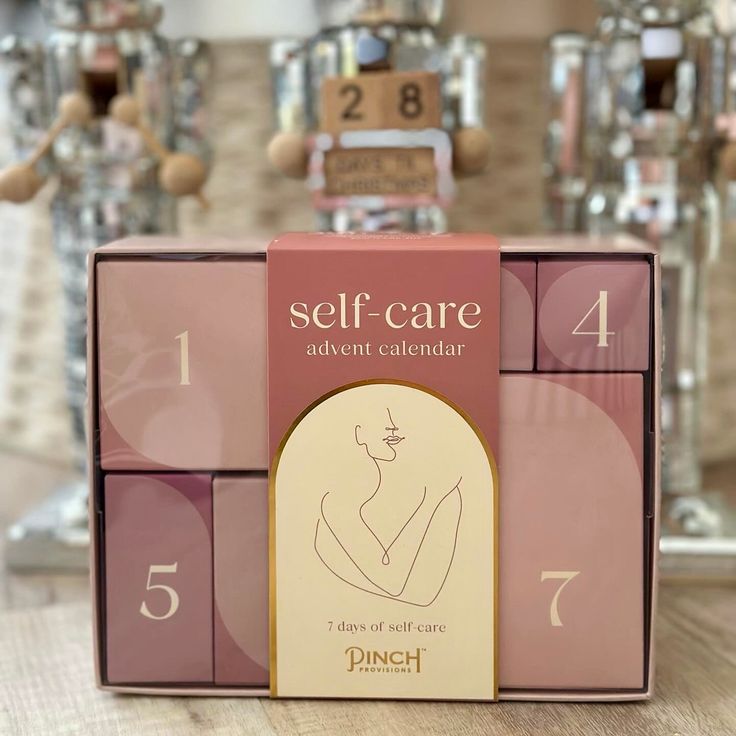 the self - care adventen calendar is on display in front of some glass vases