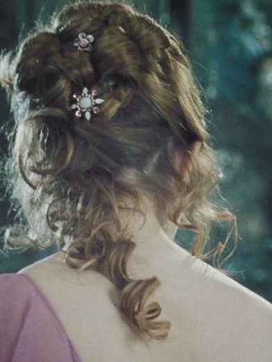 the back of a woman's head wearing a pink dress