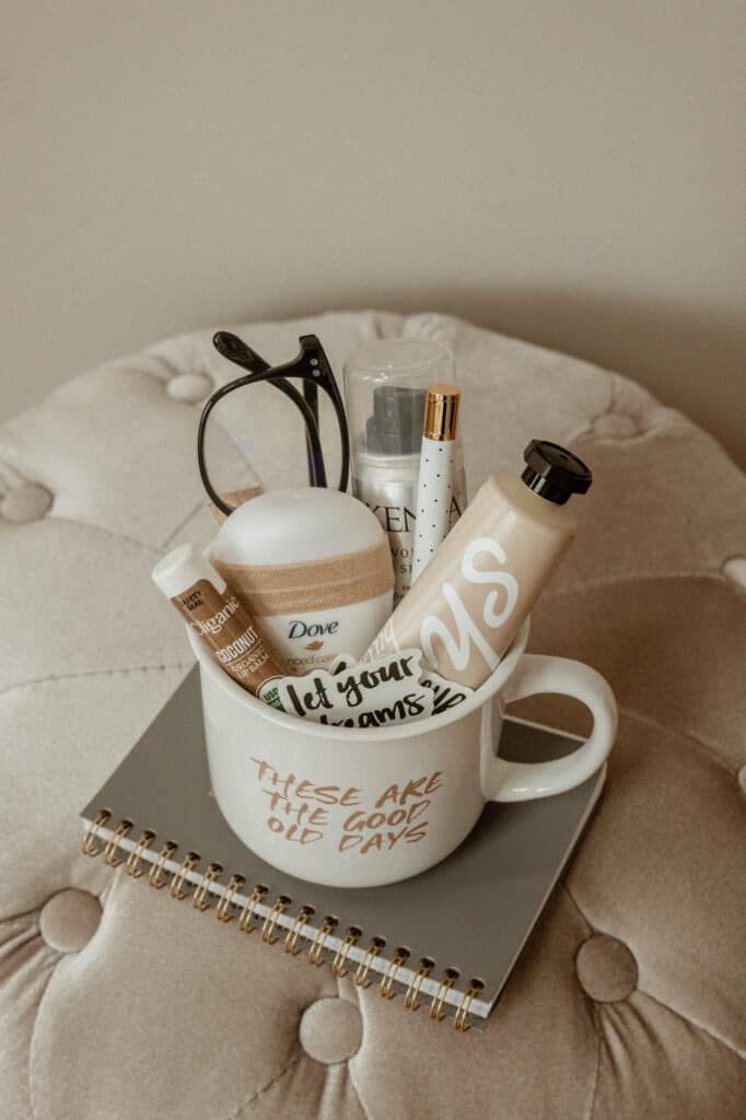 a cup filled with personal care items sitting on top of a book