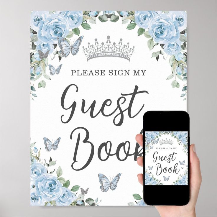 a person holding up a sign that says guest book with blue roses and butterflies around it