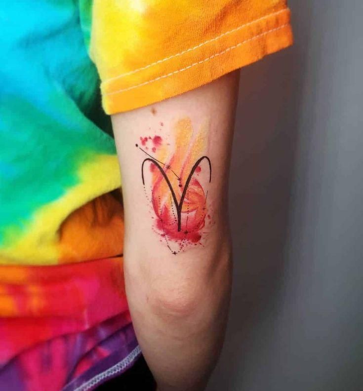 a woman's arm with a tattoo on it that has the letter v painted on it