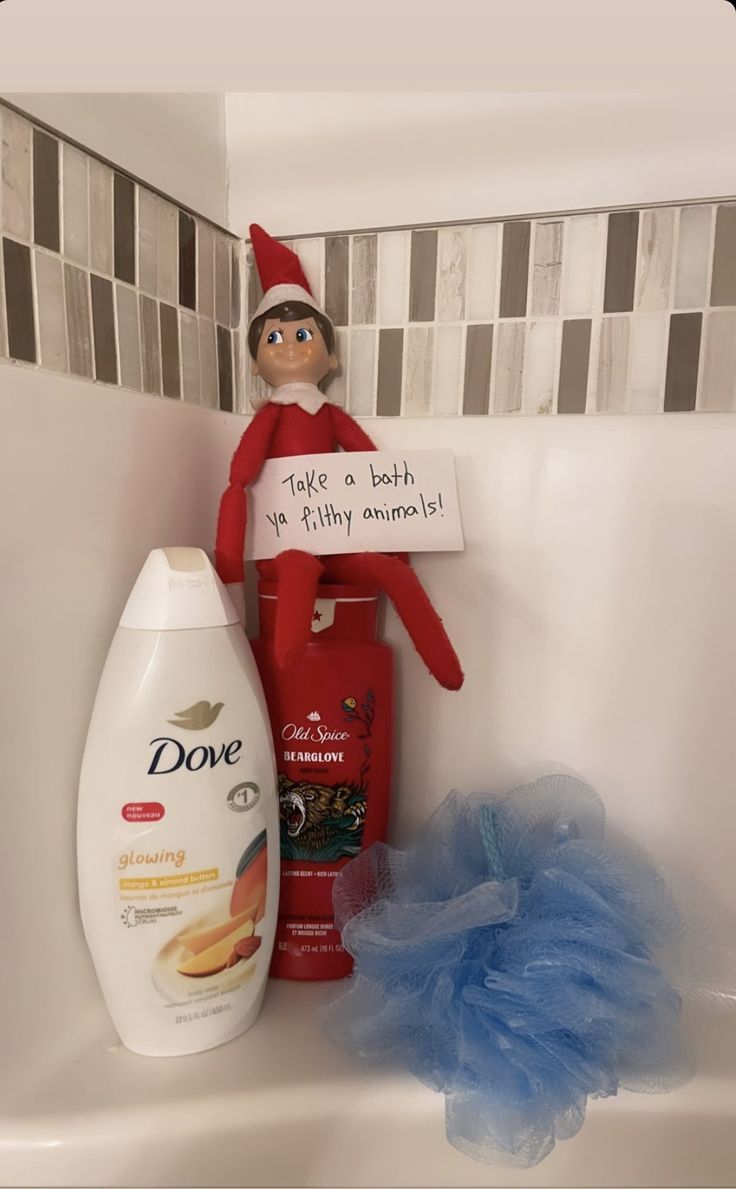 the elf is sitting in the bathtub with his hand sanitizer next to him