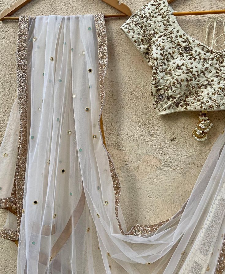 Features an Ivory Kalidaar lehenga with 32 Kalis with intricate work all over and sequin-sari work border detailing, paired with a hand embroidered zardozi and pearl work raw silk blouse and ivory mirror work dupatta Composition : Lehenga - Georgette ,Blouse - Raw Silk, Dupatta - Soft Net All products can be customised for sleeves, length of blouse and neck design Delivery : 2-4 weeks as the product is hand crafted. Check Size Guide or choose MySize for free customisation (All Sizes above XL can be made at 15% additional cost) For more information and sizes please contact fabiliciousfashion@gmail.com or visit our Copenhagen studio.About the Designer : Priti Sahni started out with a career on the well-trodden path by following typical Indian parent’s goal, to be a Computer engineer. She fin