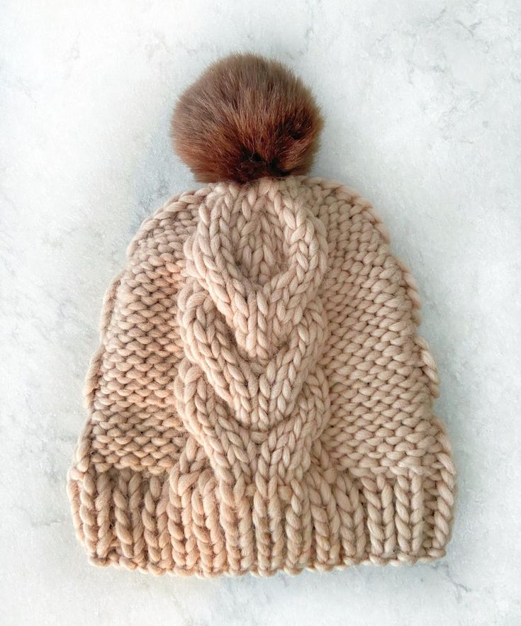 a knitted hat with a pom - pom on top