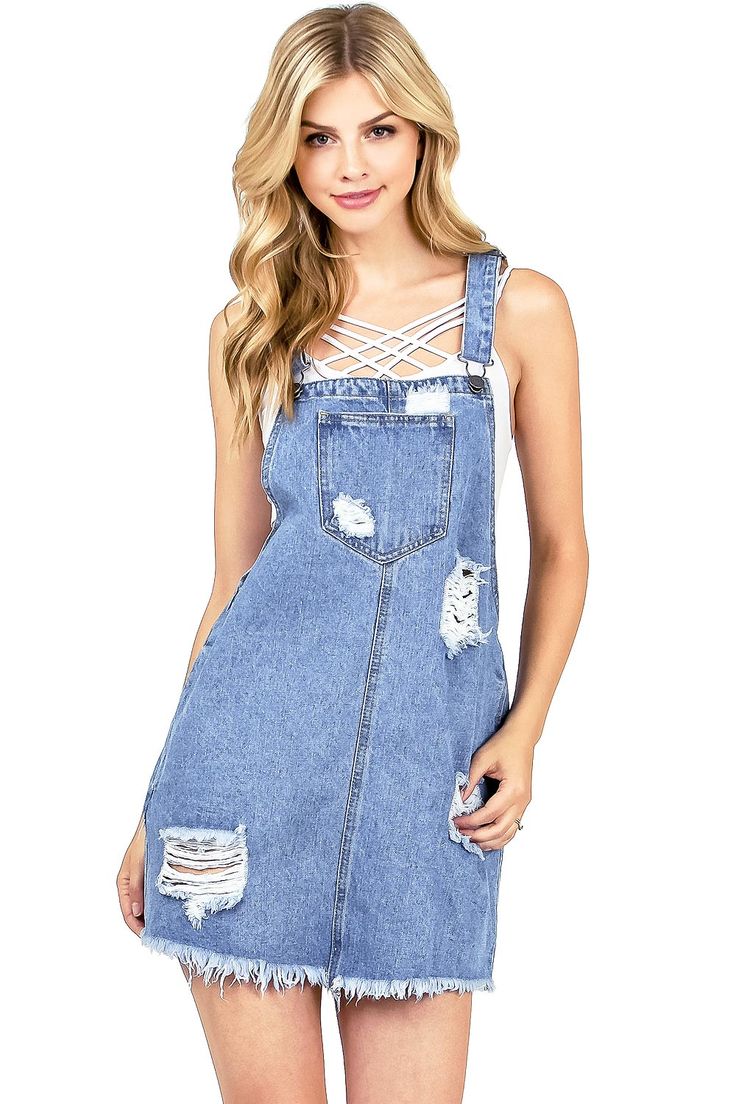 Overall?dress?with a vintage denim wash and distressing on the front and bottom hem. Traditional overall straps single pocket bib, with pockets on the sides?and back of the skirt.?Looks great layered?with a bralette or a crop top. CARE | Machine?Wash Cold CONTENTS | 100% Cotton?(MEASUREMENTS | 32"/81 cm Top to Bottom (Size Small) MODEL | 5'8 - wearing a size SmallIMPORTED Trendy Suspender Dress With Adjustable Straps, Trendy Denim Dress With Spaghetti Straps, Spring Suspender Dress With Pockets, Summer Cotton Mini Pinafore Dress, Summer Distressed Cotton Denim Dress, Spring Cotton Suspender Dress With Pockets, Casual Sleeveless Denim Pinafore Dress, Casual Mini Pinafore Dress With Pockets, Casual Mini Pinafore Dress For Spring