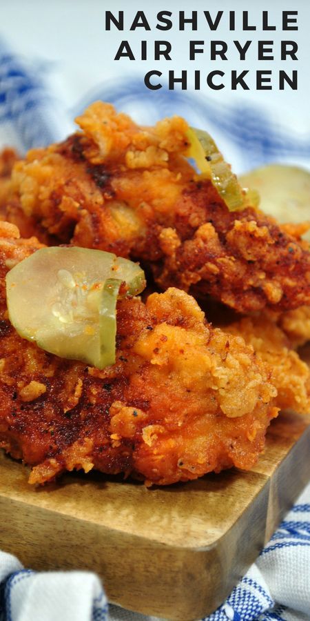 some fried food is sitting on a wooden board with the words nashville air fryer chicken