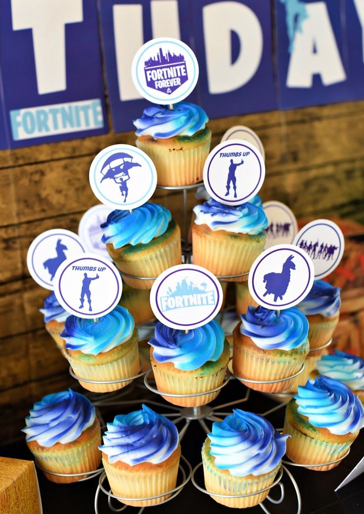 cupcakes with blue frosting are arranged in a pyramid