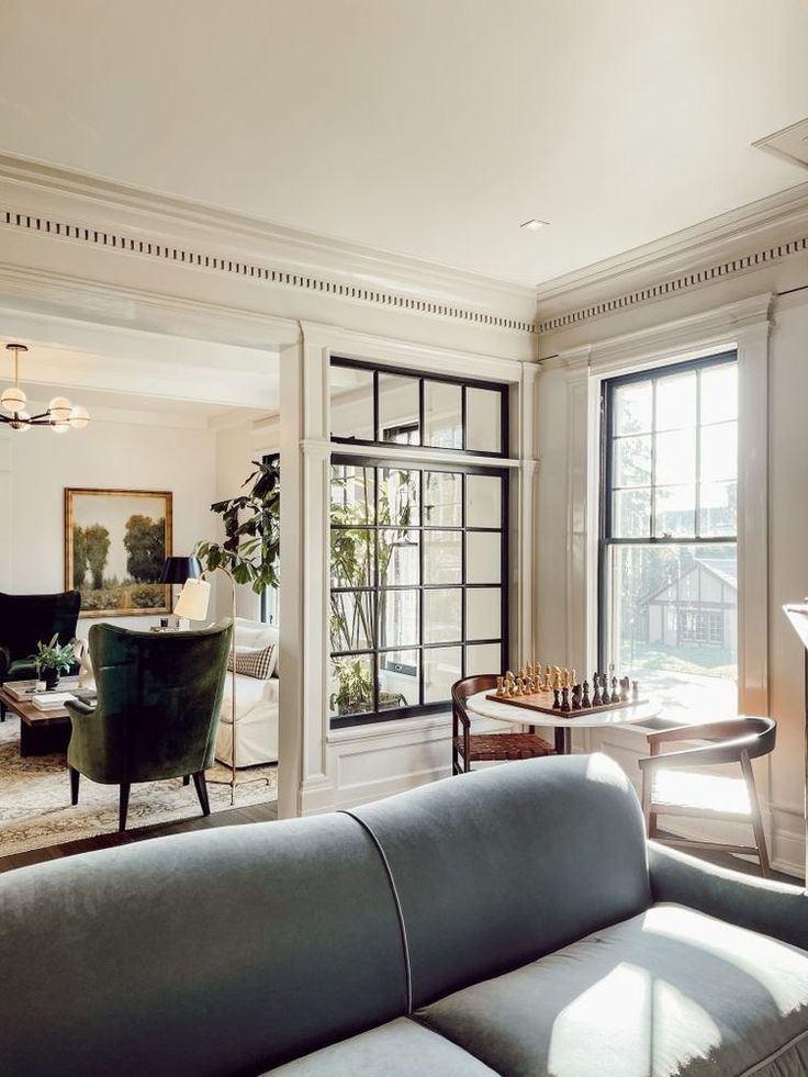 a living room filled with furniture and windows