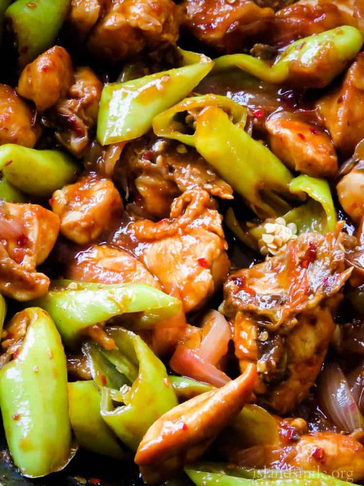 chicken and peppers stir fry in a wok