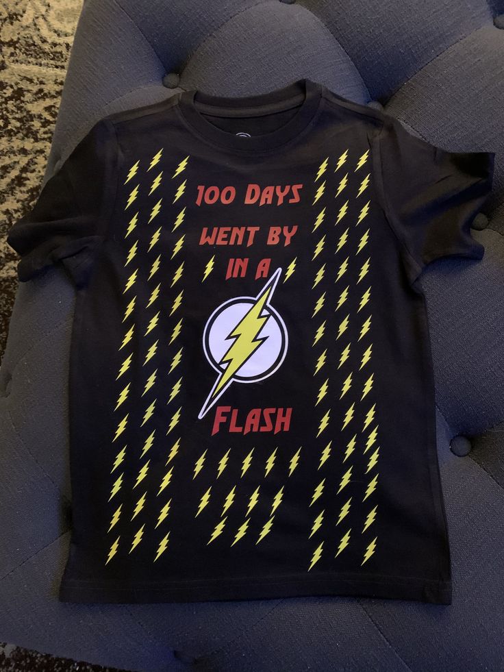 a black t - shirt with yellow lightnings and the words 100 days went by in a flash on it