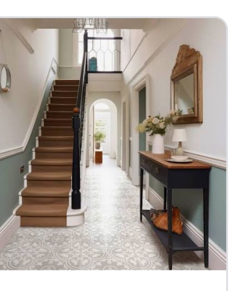 a long hallway with stairs leading up to the second floor