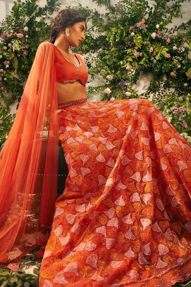 Orange attached cancan lehenga with resham, thread embroidery in floral pattern. Paired with bead embellished padded blouse and tassel dupatta.
Components: 3
Pattern: Embroidery, Embellished
Type Of Work: Resham, thread, floral, bead
Neckline: Notched
Sleeve Type: Sleeveless
Fabric: Tulle, Silk Organza, Raw Silk
Color: Orange
Other Details: 
Lehenga Length: 45 inches
Inverted rounded hem
Criss cross back
Back tassel tie-up
Tassel bordered sheer dupatta
Occasion: Wedding - Aza Fashions Diwali Reception Lace Lehenga, Designer Bollywood Lace Choli, Designer Bollywood-style Lace Choli, Lace Saree Set With Pallu For Reception, Designer Lace Lehenga For Diwali, Lace Sets With Pallu For Reception, Lace Reception Set With Pallu, Festive Floor-length Lace Choli, Traditional Drape Lace Lehenga