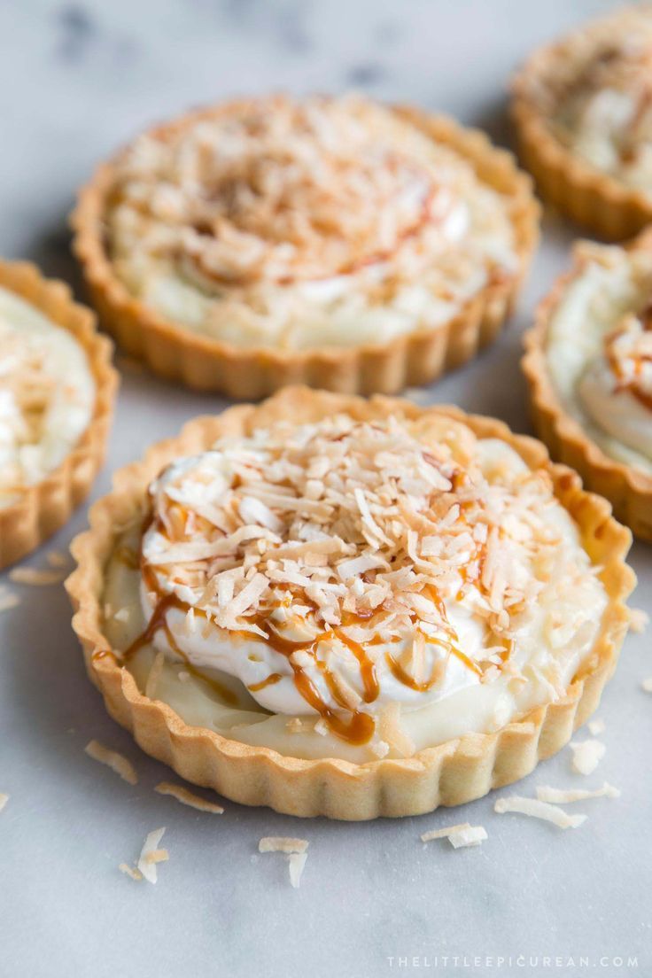 coconut cream tarts with toasted coconut on top