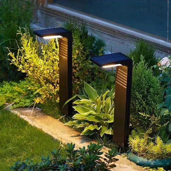 two solar powered lights are in the garden